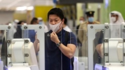 A Japanese journalist checks out the new face and iris-recognition procedures, during a media tour at Dubai airport, United Arab Emirates, Sunday, March 7, 2021. (AP Photo/Kamran Jebreili)