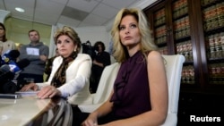 Summer Zervos, a former contestant on the TV show "The Apprentice," reacts next to lawyer Gloria Allred, left, while speaking about allegations of sexual misconduct against Donald Trump during a news conference in Los Angeles, Oct. 14, 2016.