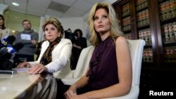 FILE - Summer Zervos, a former contestant on the TV show "The Apprentice," reacts next to lawyer Gloria Allred, left, while speaking about allegations of sexual misconduct against Donald Trump during a news conference in Los Angeles, Oct. 14, 2016.
