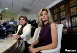 Summer Zervos, a former contestant on the TV show "The Apprentice," reacts next to lawyer Gloria Allred, left, while speaking about allegations of sexual misconduct against Donald Trump during a news conference in Los Angeles, Oct. 14, 2016.