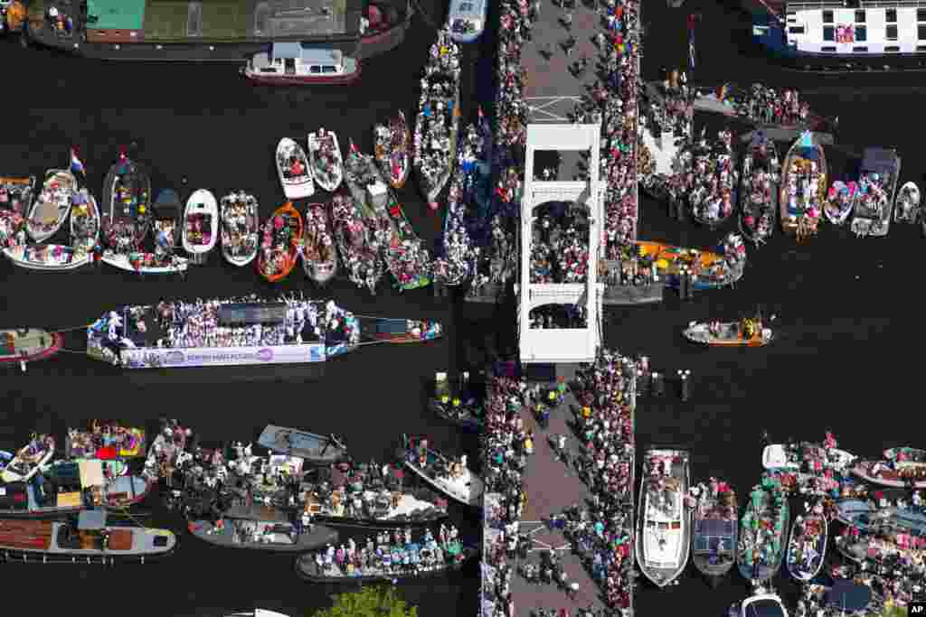 People celebrate the annual Canal Parade during the Gay Pride in Amsterdam, Netherlands, Aug. 6, 2016.