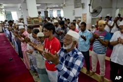 Muslim men pray at a mosque in Colombo, Sri Lanka, April 26, 2019.