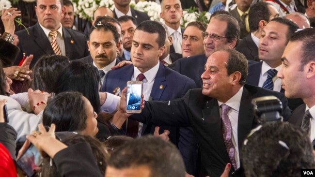 Egyptian President Abdulfattah Al-Sisi greets Coptic women at entrance of new Coptic Cathedral in Egypt, Jan 6, 2018. (H. Elrasam / VOA)