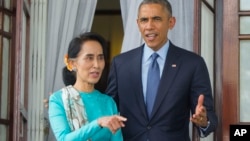 President Barack Obama, right, walks out with Myanmar's opposition leader Aung San Suu Kyi at her home before the start of their joint news conference in Yangon, Myanmar. Friday, Nov. 14, 2014. (AP Photo/Pablo Martinez Monsivais)