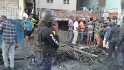 People stand at the site of an explosion in Cap-Haitien, Haiti Dec. 14, 2021, in this still image obtained from Reuters TV footage