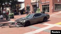A vehicle is seen reversing after plowing into the crowd gathered on a street in Charlottesville, Virginia, U.S., after police broke up a clash between white nationalists and counter-protesters, Aug. 12, 2017, in this still image from a video obtained from social media. (Courtesy of Brennan Gilmore)