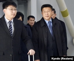 Kim Hyok Chol, right, North Korea's interlocutor leading negotiations with the United States, arrives at Beijing's international airport on his way to the Vietnamese capital Hanoi, Feb. 19, 2019.