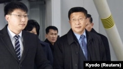 Kim Hyok Chol, right, North Korea's interlocutor leading negotiations with the United States, arrives at Beijing's international airport on his way to the Vietnamese capital Hanoi, Feb. 19, 2019.