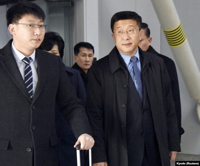 Kim Hyok Chol, right, North Korea's interlocutor leading negotiations with the United States, arrives at Beijing's international airport on his way to the Vietnamese capital Hanoi, Feb. 19, 2019.