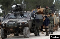 FILE - Turkish forces and members of the Free Syrian Army are seen on the outskirts of al-Bab, Feb. 4, 2017.