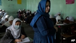 Afghan girls listen their teacher at Tajrobawai Girls High School, in Herat, Afghanistan, Thursday, Nov. 25, 2021. (AP Photo/Petros Giannakouris)