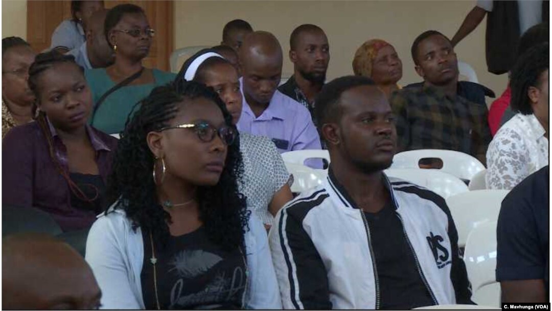 Youths follow proceedings as leaders tell them about the dangers of taking drugs.
