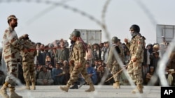 FILE - People wait to cross into Afghanistan at the Pakistani border post Chaman, Sept. 1, 2016.