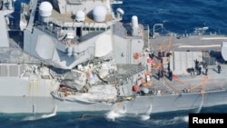 The Arleigh Burke-class guided-missile destroyer USS Fitzgerald, damaged by colliding with a Philippine-flagged merchant vessel, is seen off Shimoda, Japan, June 17, 2017, in this photo taken by Kyodo.