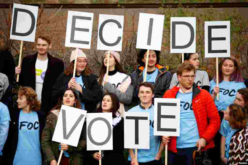 A group of young people hold up placards during a demonstration to demand a second referendum on Brexit outside the Houses of Parliament in London.