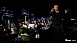 U.S. Democratic presidential candidate Bernie Sanders, with his wife Jane, addressess supporters from the bed of a pickup truck after arriving early morning in Bow, New Hampshire from Iowa Feb. 2, 2016.