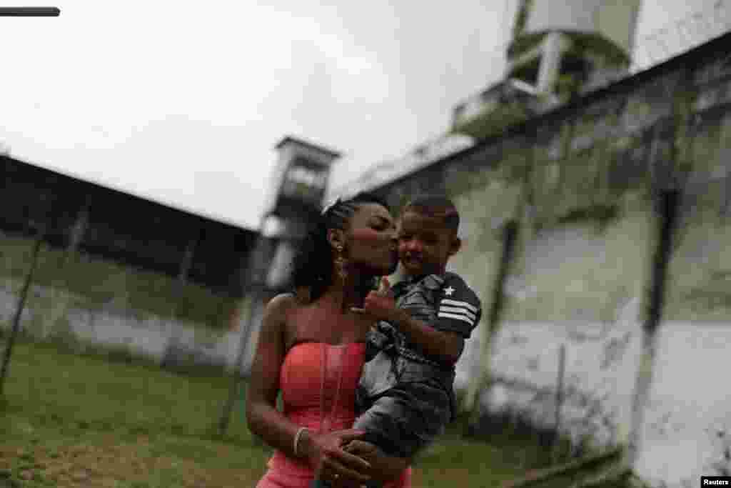 A prisoner and participant of the "TB Girl" beauty contest holds her son at the Talavera Bruce women prison in Rio de Janeiro, Brazil.