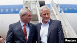 U.S. Defense Secretary Chuck Hagel (R) is greeted by U.S. Ambassador to Singapore Kirk Wagar upon his arrival in Singapore May 30, 2014. 