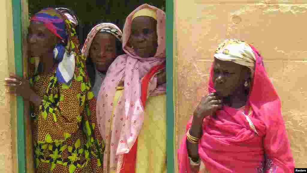 Women peer out of a doorway at a VVF centre for fistula in Kano, northern Nigeria.