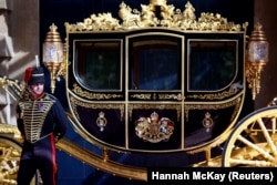 FILE - A member of the King's Troop stands next to the Jubilee Carriage in the courtyard of the Royal Mews at Buckingham Palace in London, Britain, September 21, 2021. (REUTERS/Hannah McKay)