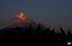 In this Thursday, May 2, 2019 photo, the Popocatepetl volcano releases a plume of ash as seen from the flanks of the Iztaccíhuatl volcano, near Santiago Xalitzintla, Mexico. (AP Photo/Marco Ugarte)