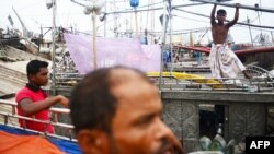 Bangladeshi fishermen tie up their vessels in the harbor of Chittagong during preparations for the expected arrival of Cyclone Mahasen, May 15, 2013.