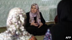 Kurdistan Rasul, center, an Iraqi Kurdish activist with the nonprofit organization WADI, speaks to women and young girls about the harms of genital mutilation in Sharboty Saghira, a small village east of Irbil, Dec. 3, 2018.