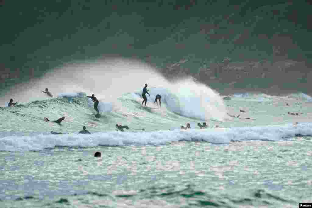 Surfers catch waves at Zorriola beach after adults were allowed out to exercise for the first time in seven weeks, as the government began easing coronavirus disease (COVID-19) restrictions, in San Sebastian, Spain, May 2, 2020.