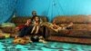 A Syrian refugee from Aleppo sits with his children in a makeshift tent in a Syrian refugee camp in the town of Kab Elias in Lebanon's Bekaa Valley, June 20, 2016.