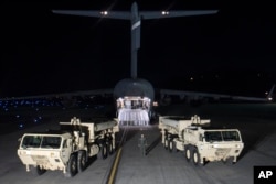 In this photo provided by U.S. Forces Korea, trucks carrying parts of U.S. missile launchers and other equipment needed to set up A Terminal High Altitude Area Defense (THAAD) system arrive at Osan air base in Pyeongtaek, South Korea, March 6, 2017.