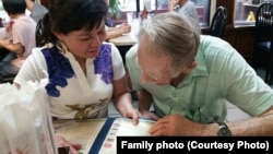 Nguyễn Thị Kim Nga, left, helps her father, Gary Wittig, decide on Vietnamese dinner during their first meeting in Atlanta.