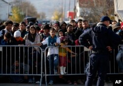 Migrants wait to register with police at a refugee center in the southern Serbian town of Presevo, Nov. 16, 2015.