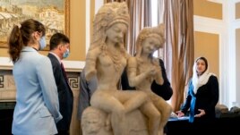 Afghan Ambassador to the U.S. Roya Rahmani, right, accompanied by embassy staff, speaks as she gives the Associated Press a tour at the Afghanistan Embassy in Washington, Wednesday, April 21, 2021