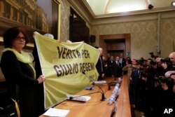 Paola, the mother of Giulio Regeni, holds a banner reading: Truth for Giulio Regeni, prior to the start of a press conference held at the Italian Senate, in Rome, Tuesday, March 29, 2016.