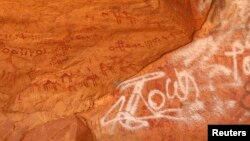 Vandalized rock art is pictured at Tadrart Acacus, in Ghat, Libya, May 30, 2014.