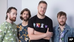 FILE - Members of Imagine Dragons, from left, Daniel Platzman, Wayne Sermon, Dan Reynolds and Ben McKee are seen in New York, June 20, 2017.