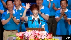 Backed by the ruling Nationalist Party members, Hung Hsiu-chu, a former teacher and current deputy legislative speaker, waves as she is nominated as the party's candidate in the January presidential election, July 19, 2015, in Taipei, Taiwan.