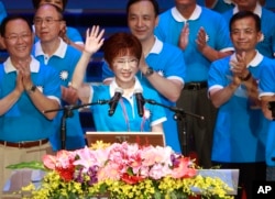 FILE - Backed by the ruling Nationalist Party members, Hung Hsiu-chu, a former teacher and current deputy legislative speaker, waves as she is nominated as the party's candidate in the January presidential election, July 19, 2015, in Taipei, Taiwan.