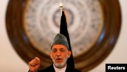 FILE - Outgoing Afghan President Hamid Karzai speaks during a gathering of government employees in Kabul Sept. 23, 2014.
