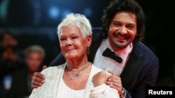 Actors Ali Fazal and Judi Dench pose during a red carpet for the movie "Victoria and Abdul" at the 74th Venice Film Festival in Venice, Italy, Sept. 3, 2017.
