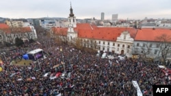 People gather at Slovak National Uprising (SNP) square during a rally under the slogan "For a Decent Slovakia," against corruption and to pay tribute to murdered Slovak journalist Jan Kuciak and his fiancee Martina Kusnirova on March 9, 2018 in Bratislava.