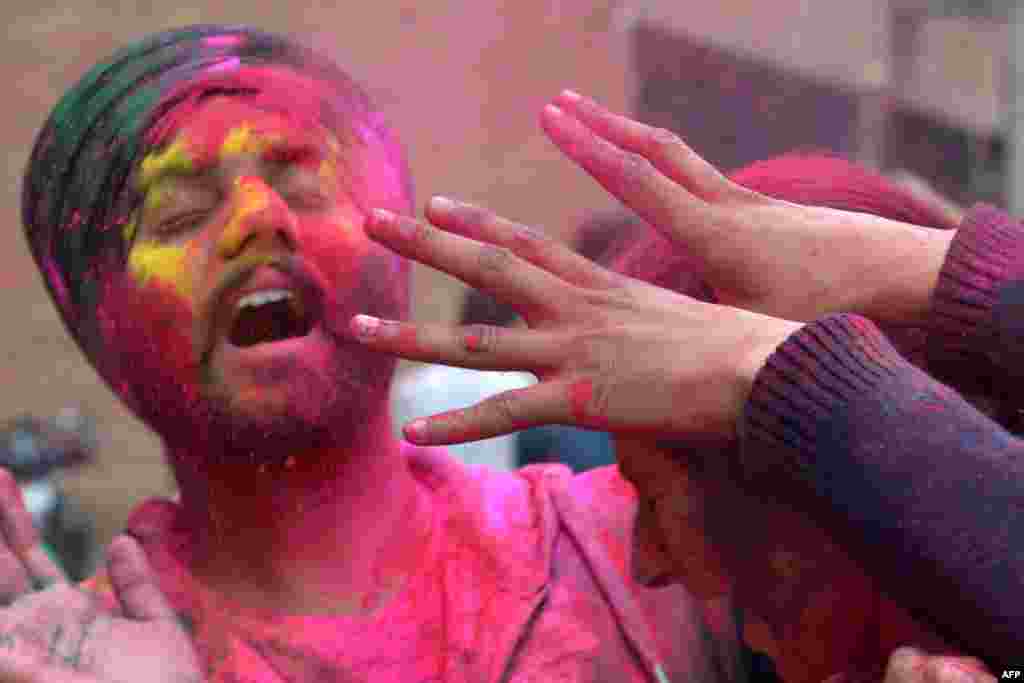 Students celebrate the Holi festival with colored powder at Guru Nanak Dev University in Amritsar, India.