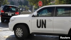 U.N. vehicles carrying chemical weapons experts leave their hotel in Damascus October 5, 2013.