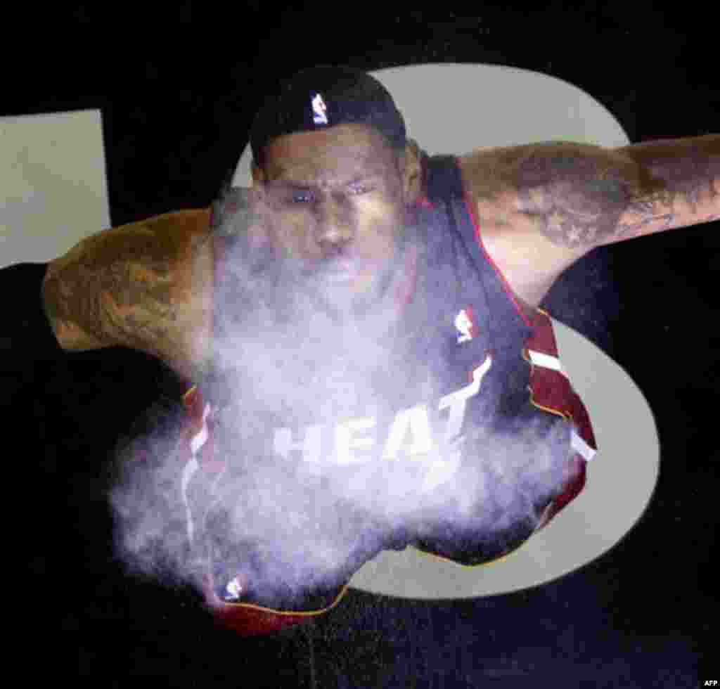Miami Heat's LeBron James throws powder into the air prior to the team's NBA preseason basketball game against the San Antonio Spurs, Saturday, Oct. 9, 2010 in San Antonio. (AP Photo/Eric Gay)