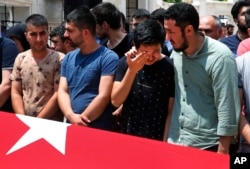 Relatives gather around the Turkish flag-draped coffin of Habibullah Sefer, one of the victims killed Tuesday at the blasts in Istanbul's Ataturk airport, during the funeral in Istanbul, June 30, 2016.