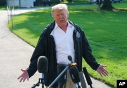 President Donald Trump talks to media before boarding Marine One on the South Lawn of the White House in Washington, Sept. 19, 2018, for the short trip to Andrews Air Force Base en route to Havelock, N.C.