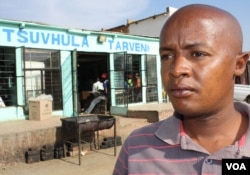 Community health care worker Brown Lekekela stands outside a tavern in a township in South Africa, where young women often meet older men with whom they have dangerous "transactional" sexual relationships. (D. Taylor/VOA)