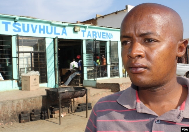 Community health care worker Brown Lekekela stands outside a tavern in a township in South Africa, where young women often meet older men with whom they have dangerous "transactional" sexual relationships. (D. Taylor/VOA)