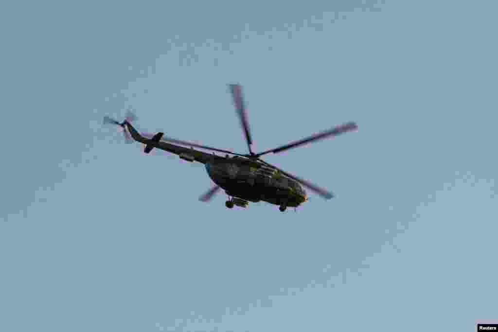 A Russian military helicopter flies near Simferopol, March 3, 2014.
