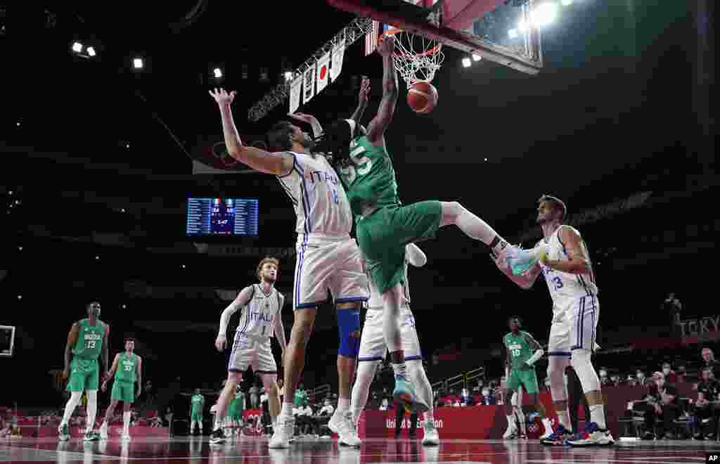 Nigeria&#39;s Precious Achiuwa (55) scores past Italy&#39;s Danilo Gallinari (8) during men&#39;s basketball preliminary round game at the 2020 Summer Olympics, Saturday, July 31, 2021, in Saitama, Japan. (AP Photo/Eric Gay)